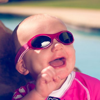 Happy child in Baby Banz Adventure Banz Pink sunglasses