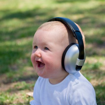 Baby laughing while wearing Mini Earmuffs in Silver