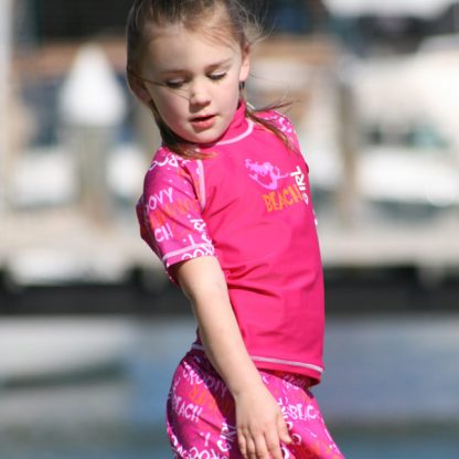 Girl in short-sleeved Pink Graffiti rash shirt