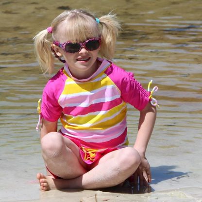 Girl in a short-sleeved Sun Blossom Stripe rash shirt